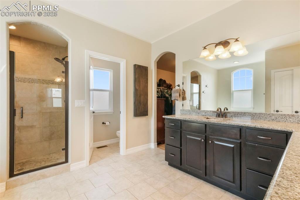 Image 26 of 50: Upper level primary 5 piece bathroom and large walk in closet