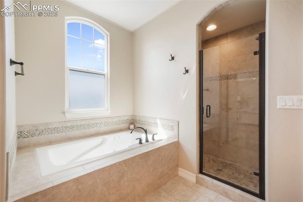 Image 28 of 50: Upper level primary 5 piece bathroom and large walk in closet