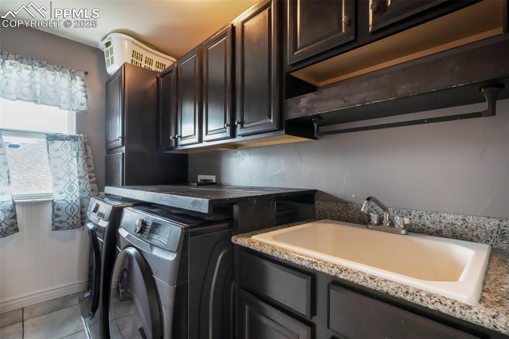 Image 33 of 50: Upper level laundry room with window and sink