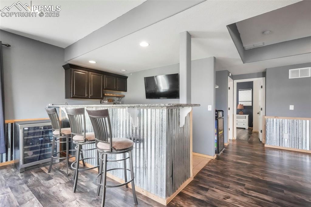 Image 38 of 50: Basement level family room, walk out patio access and wet bar