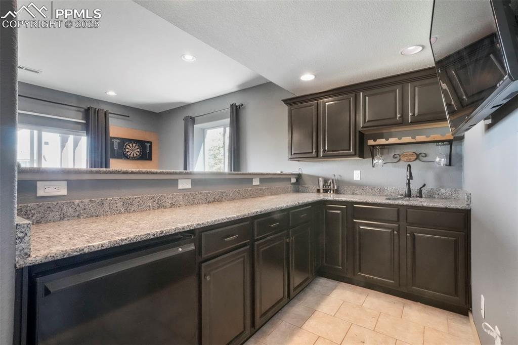 Image 39 of 50: Basement level wet bar