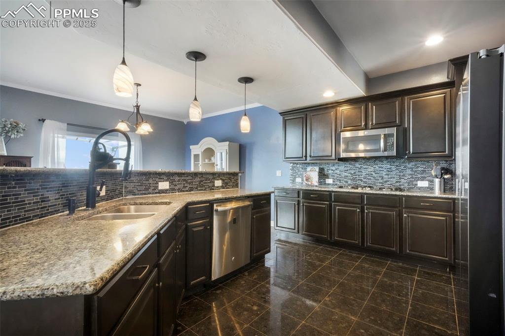 Image 6 of 50: Kitchen with granite counters, stainless steel appliances, large walk in pa