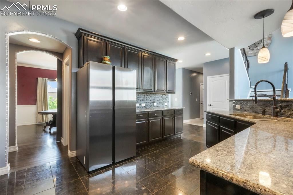 Image 8 of 50: Kitchen with granite counters, stainless steel appliances, large walk in pa