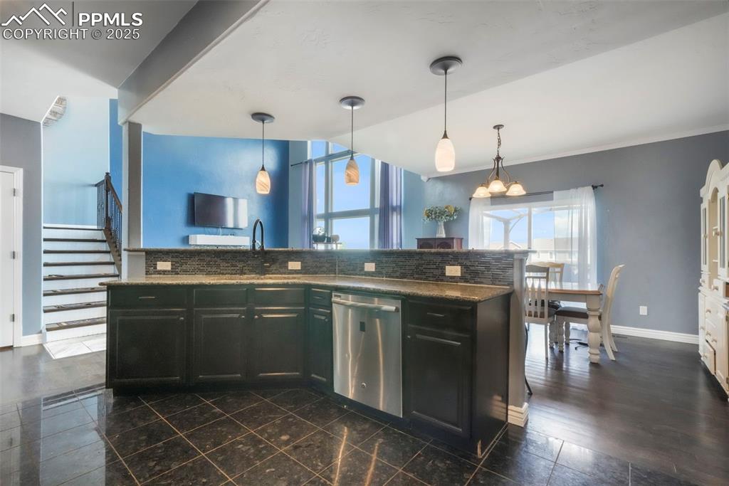 Image 9 of 50: Kitchen with granite counters, stainless steel appliances, large walk in pa