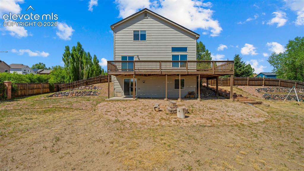 Image 35 of 50: Extensive back deck and enormous back yard.