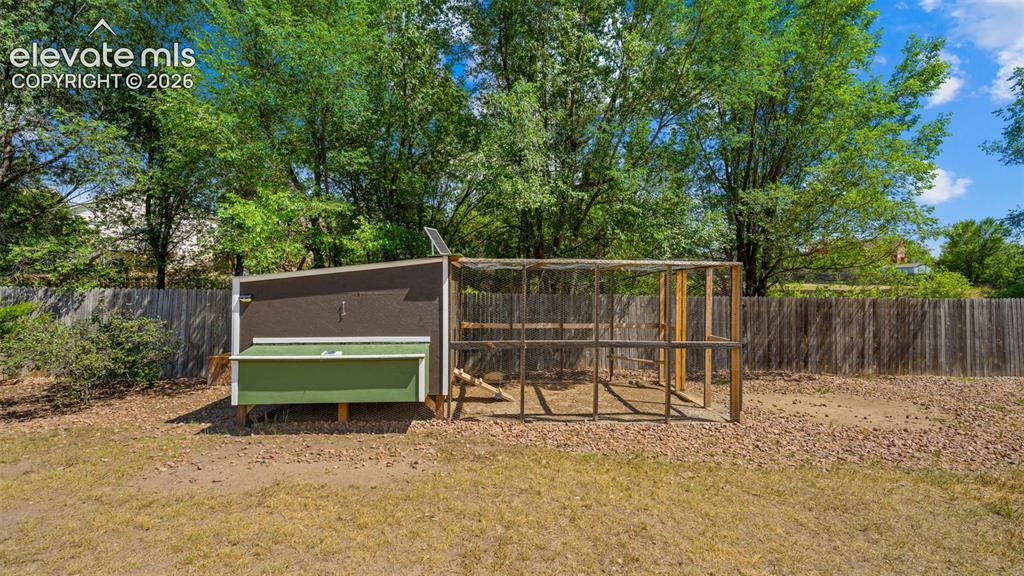 Image 38 of 50: Chicken coop included!