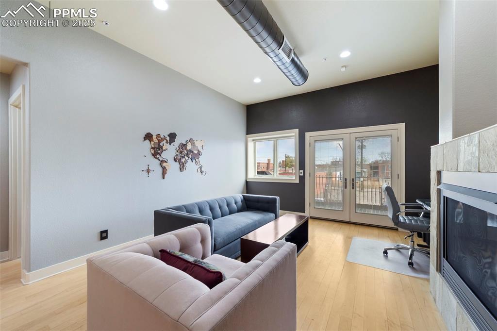 Image 12 of 40: Living room with hardwood floors, recessed lighting, french doors, and a de
