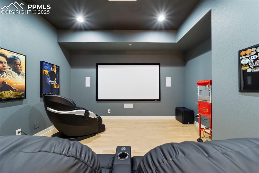Image 15 of 40: Theater room with hardwood floors and recessed lighting