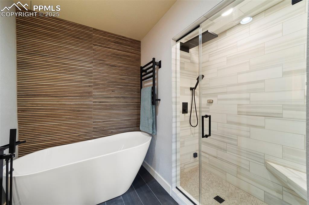 Image 21 of 40: Primary Full bath just renovated and featuring a spacious walk-in closet, a