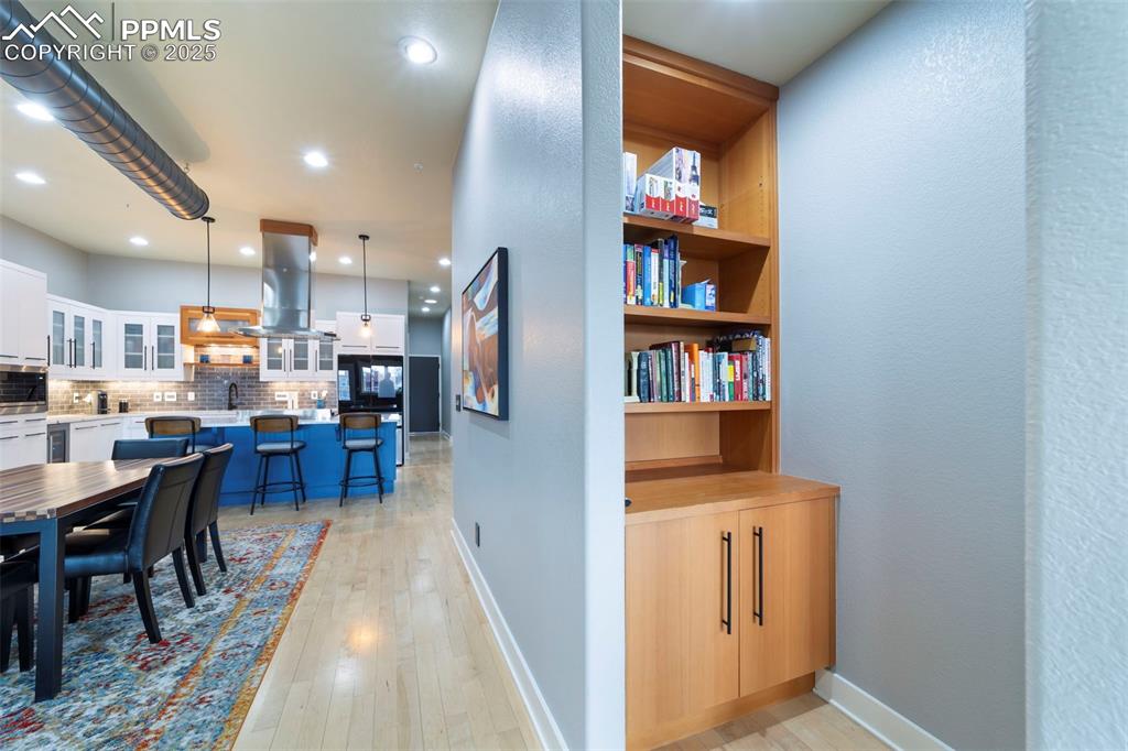Image 24 of 40: Dining room with hardwood flooring, recessed lighting