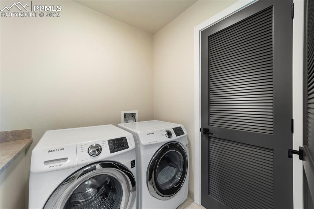 Image 30 of 40: Laundry room featuring washer and clothes dryer