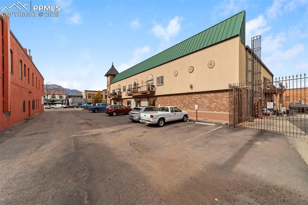 Image 31 of 40: Additional parking lot with a mountain view and a gate