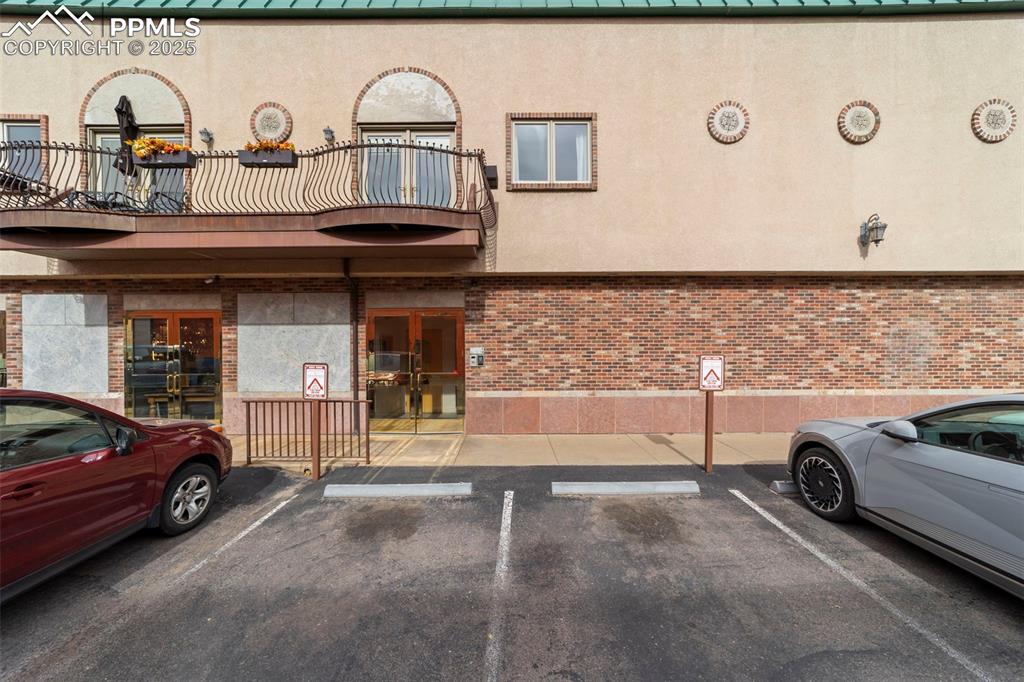 Image 35 of 40: View of building exterior featuring uncovered bonus parking