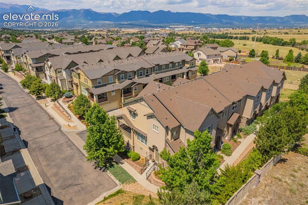 Image 24 of 26: Townhome community with varied architectural styles, multi-level designs, a