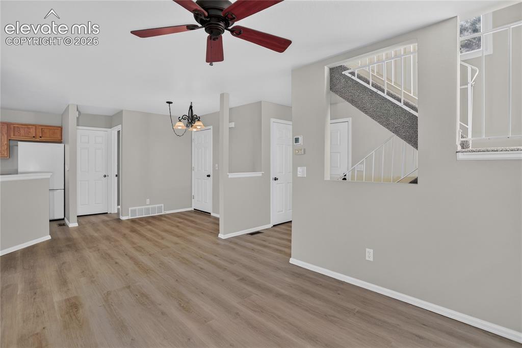Image 12 of 44: Open-concept living area showcasing wood-finish flooring throughout, multip