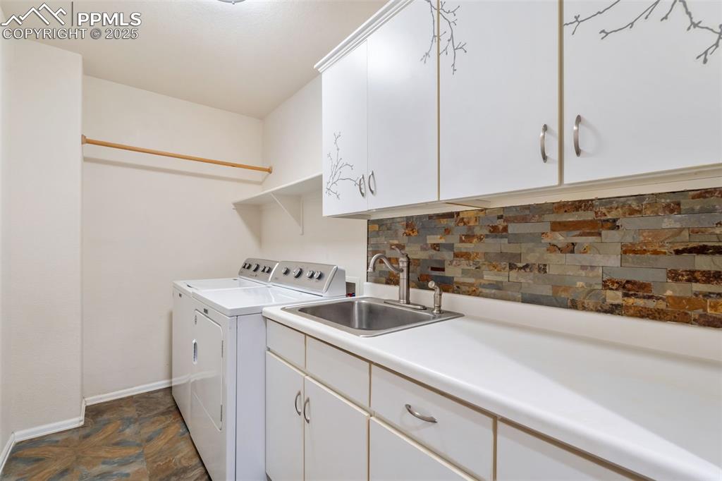 Image 29 of 50: Laundry area featuring cabinet space and washer and clothes dryer