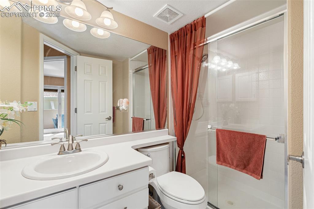 Image 32 of 50: Full bathroom with a shower stall and vanity