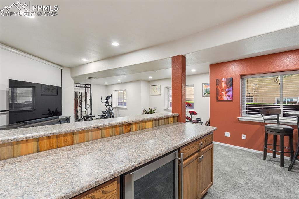 Image 39 of 50: Kitchen featuring wine cooler, recessed lighting, healthy amount of natural