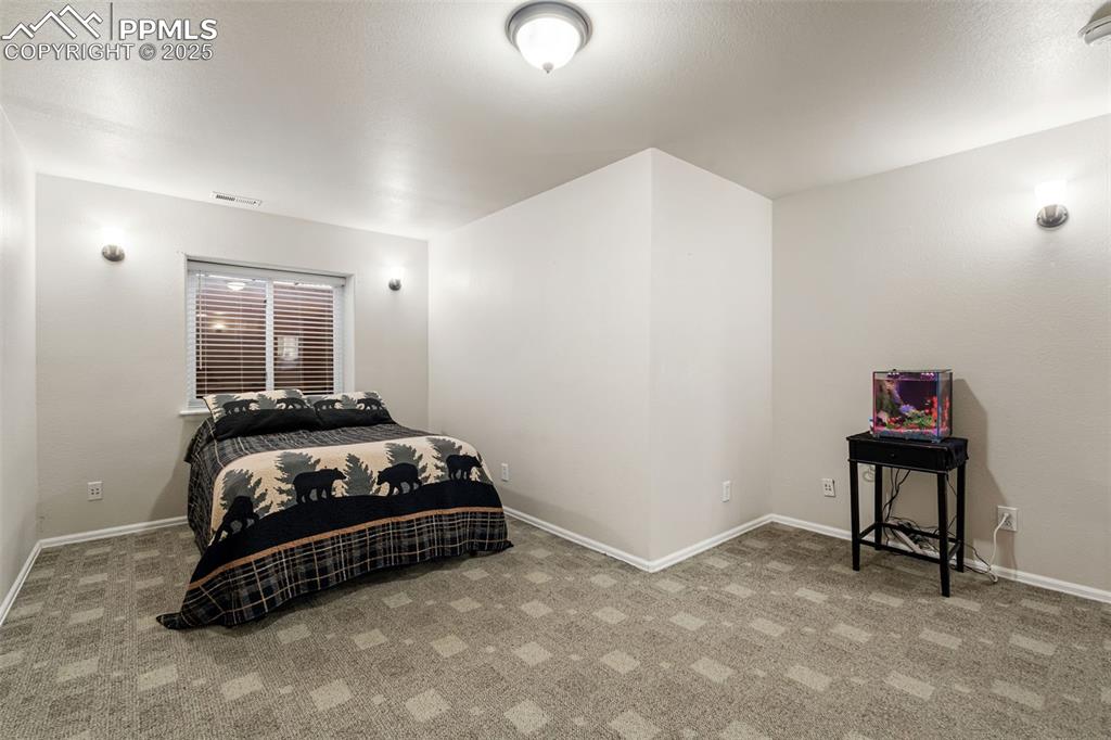 Image 42 of 50: Bedroom with carpet and baseboards
