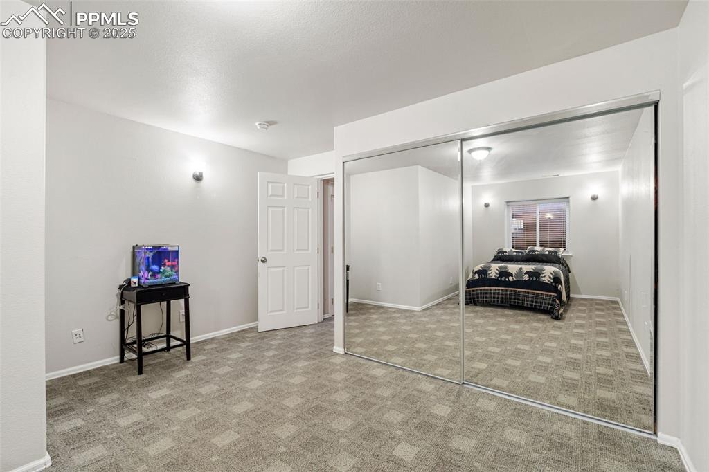 Image 43 of 50: Bedroom with a closet and light carpet