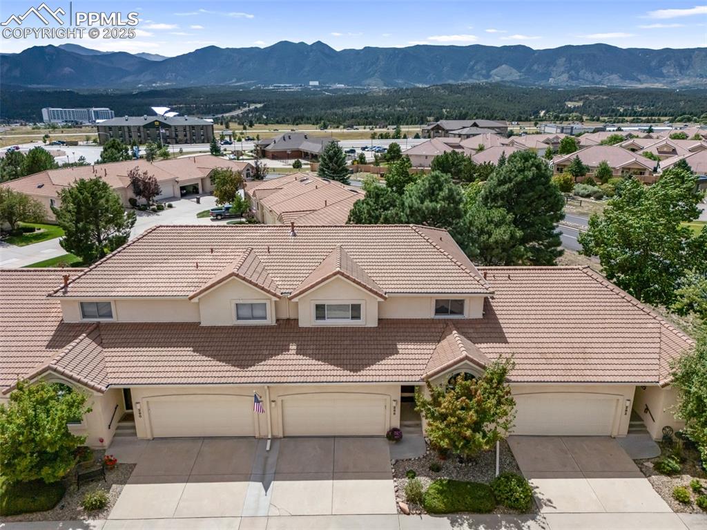 Image 45 of 50: Aerial view of residential area with a mountain backdrop