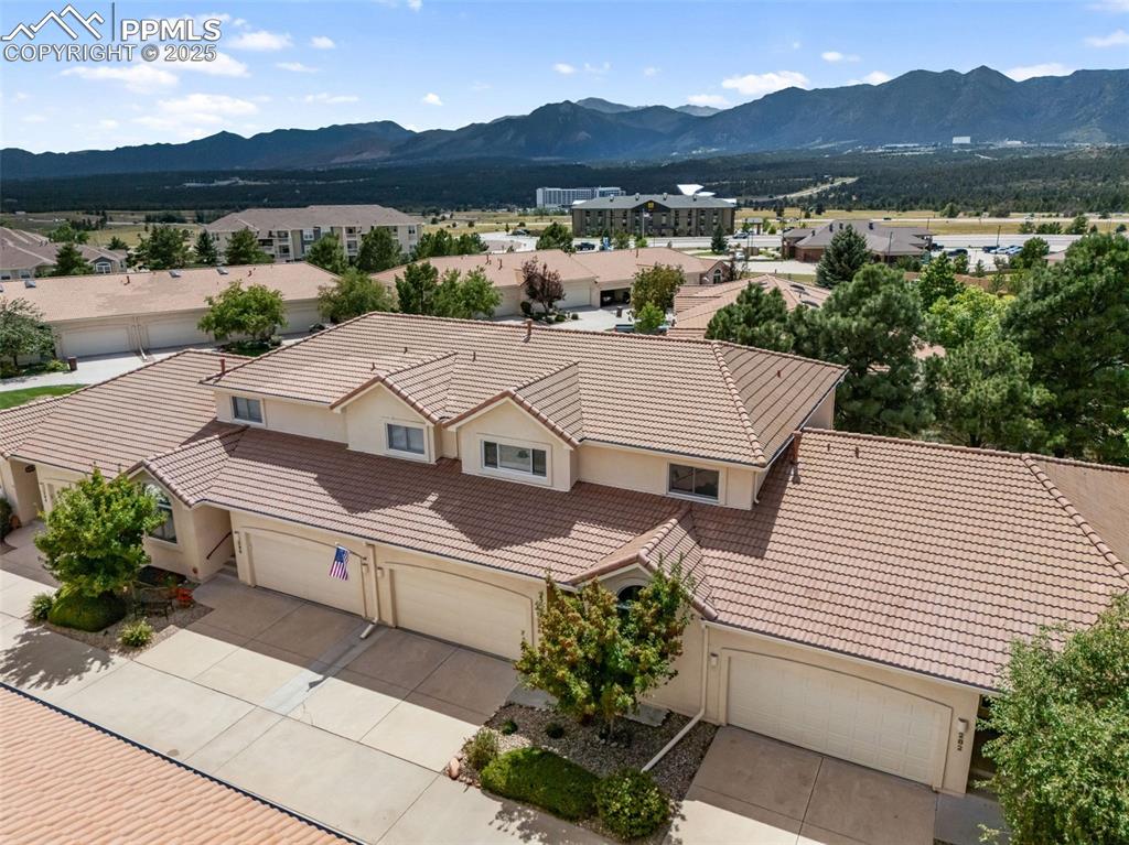 Image 46 of 50: Aerial view of residential area featuring mountains