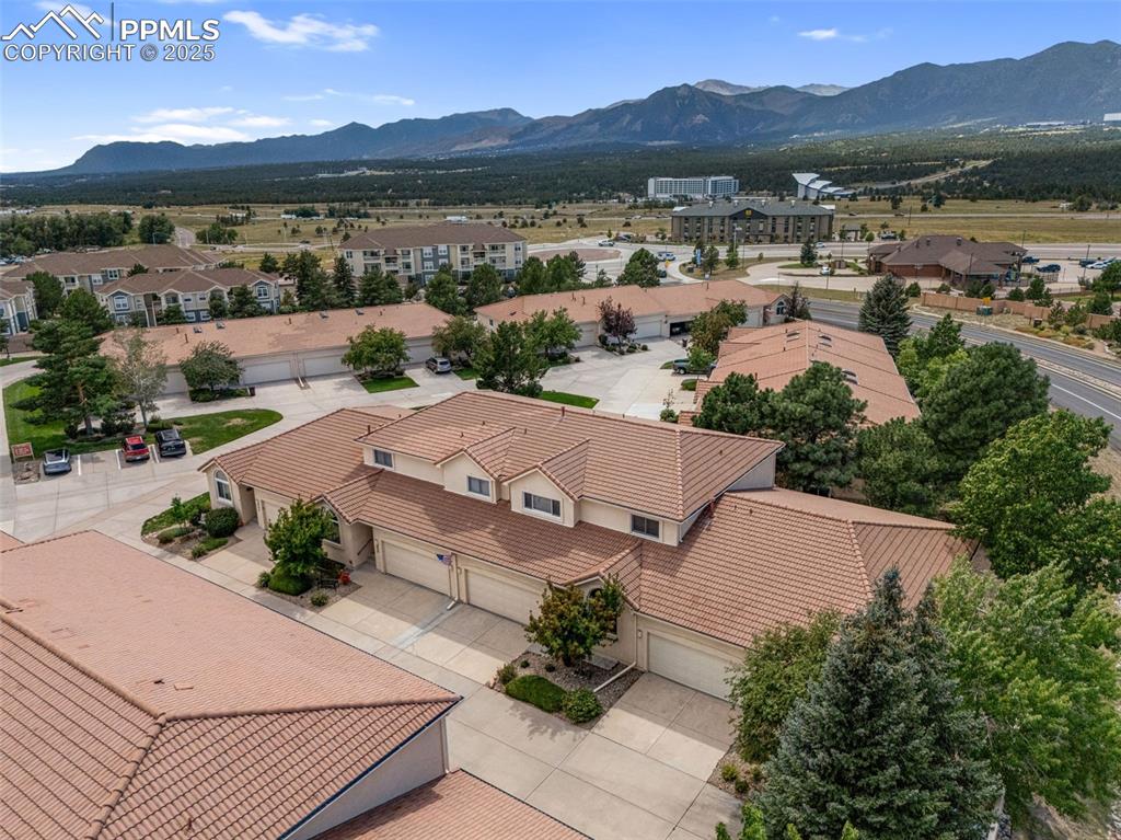 Image 47 of 50: Aerial view of residential area with a mountain backdrop