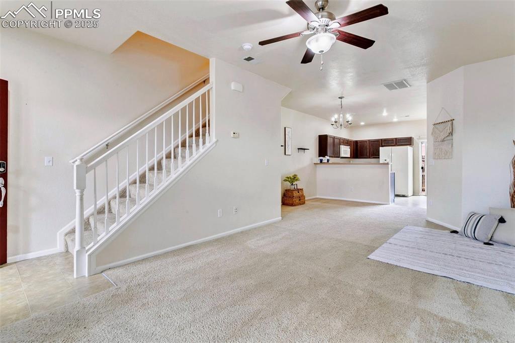 Image 5 of 26: Living area looking towards kitchen and staircase
