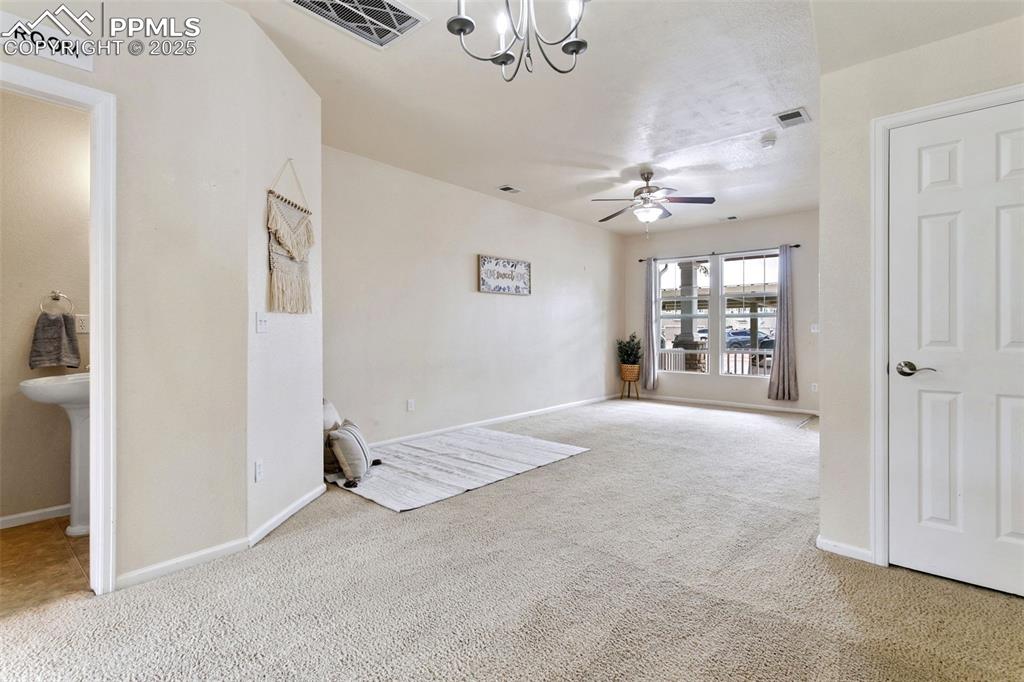 Image 7 of 26: Living area w/ bathroom on left side