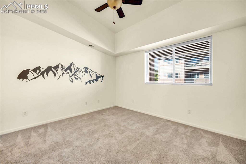 Image 18 of 37: Carpeted empty room featuring ceiling fan and baseboards