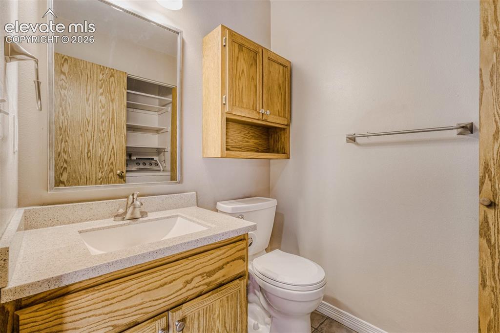 Image 15 of 32: 1/2 Bath with Laundry & Storage shelf