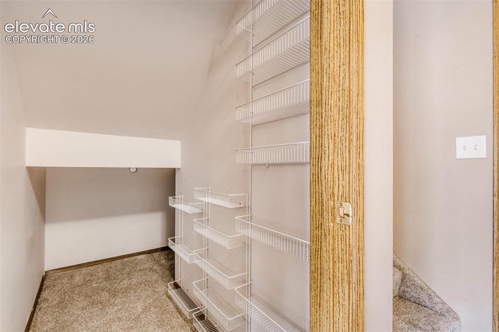 Image 16 of 32: Large storage closet with additional shelving