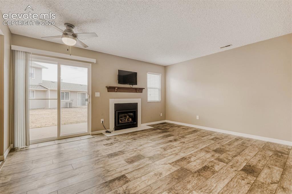 Image 7 of 32: Gas fireplace and bonus mounted television