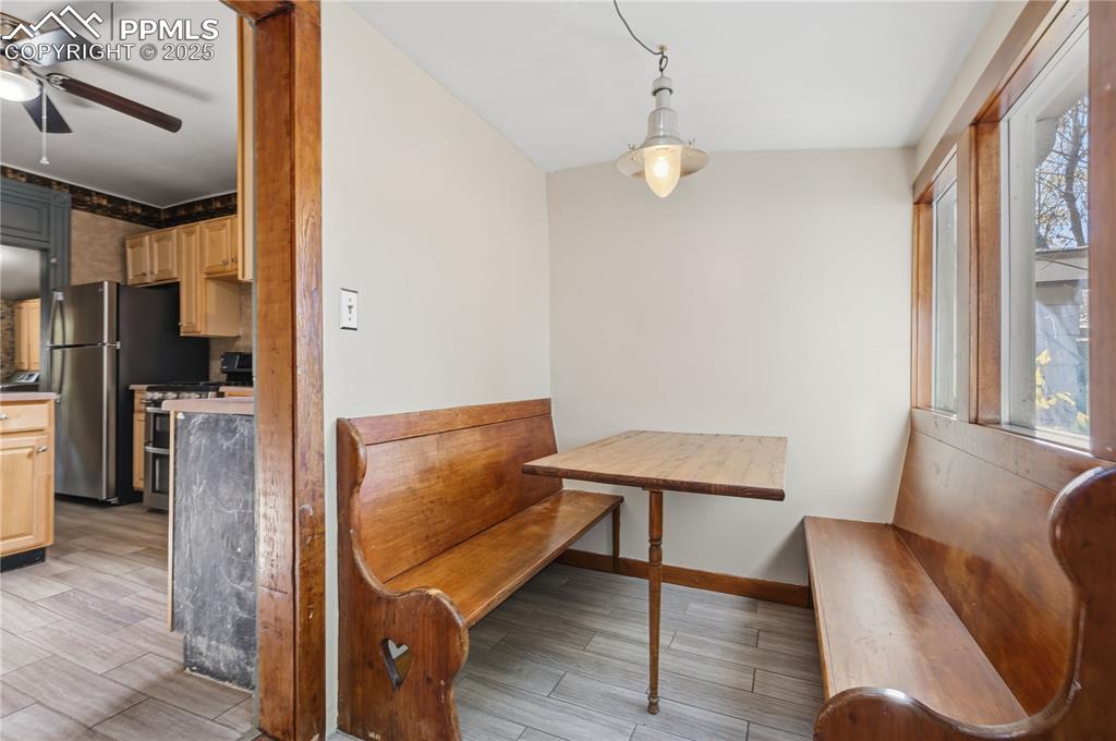 Image 18 of 36: Dining space with wood finish floors and ceiling fan