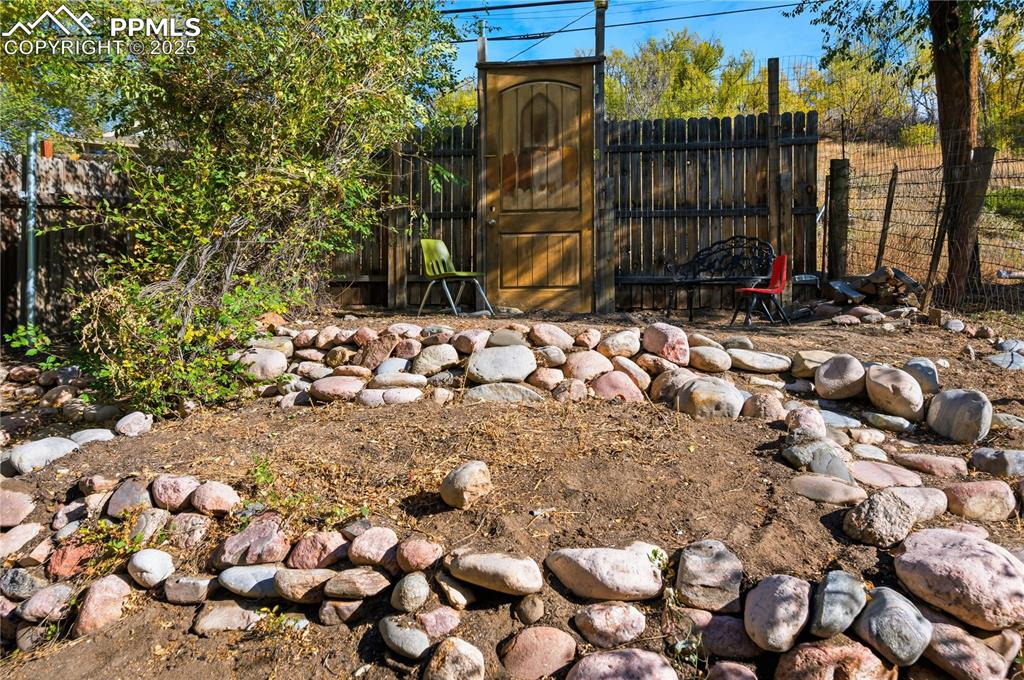 Image 28 of 36: View of fenced backyard