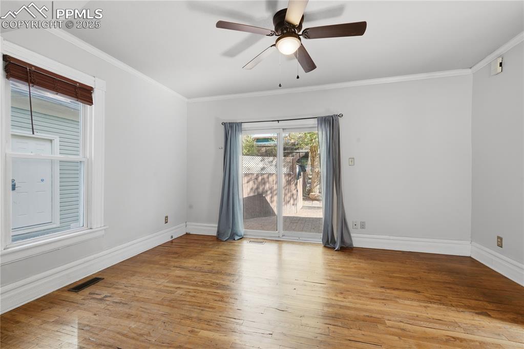 Image 9 of 36: Spare room with light wood finished floors, ornamental molding, and a ceili