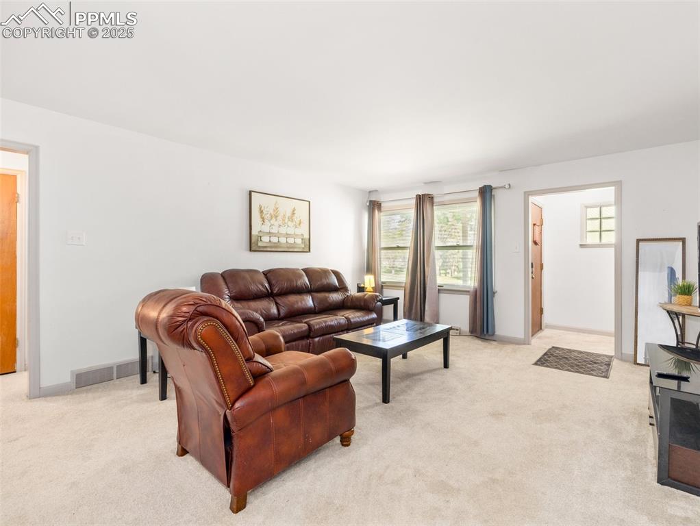 Image 10 of 18: Living room with light carpet