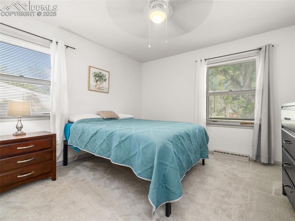 Image 4 of 18: Bedroom featuring light colored carpet and a ceiling fan