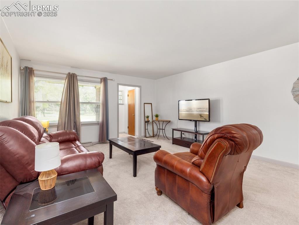 Image 9 of 18: Living area with light carpet