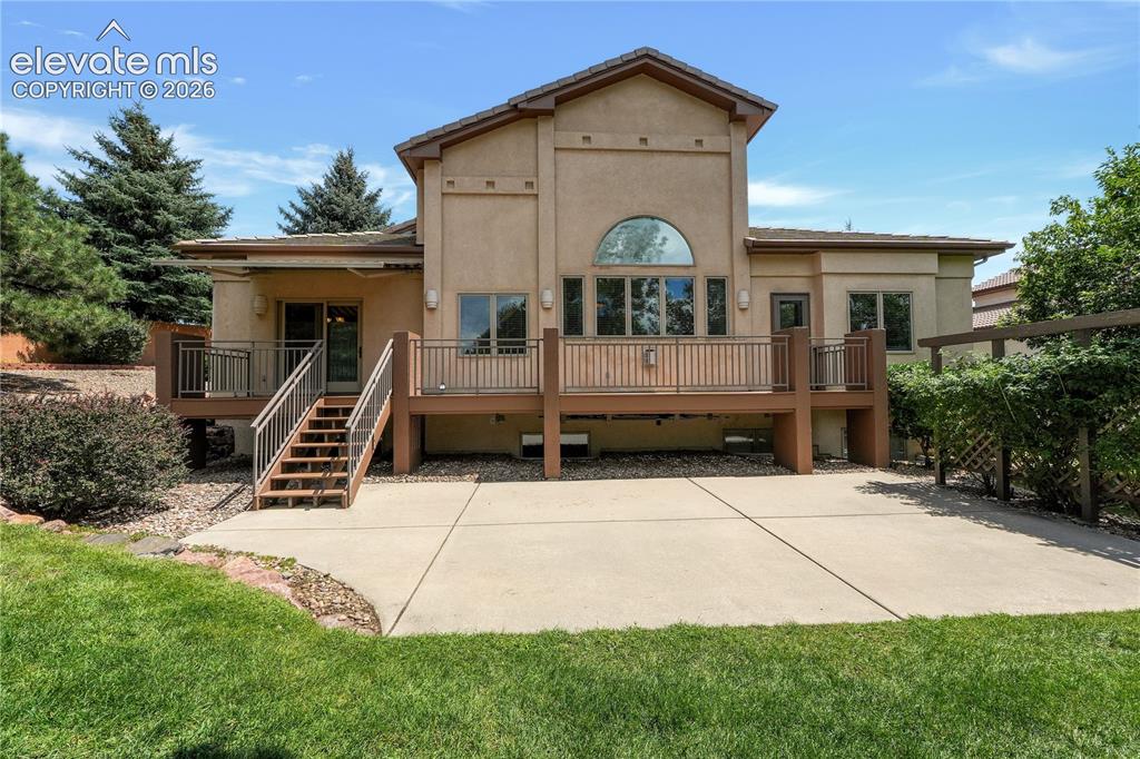 Image 28 of 35: Large patio with mature landscaping 