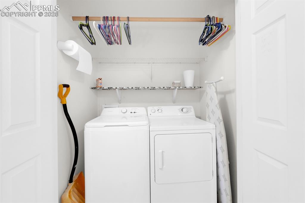 Image 11 of 15: Laundry area with washing machine and dryer