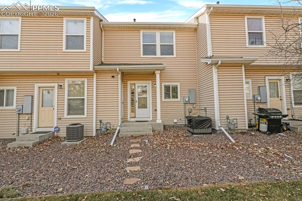 Image 14 of 15: Rear view of house with entry steps