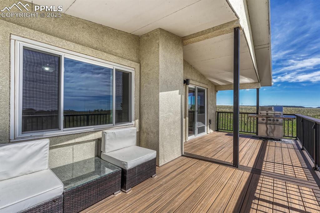 Image 11 of 50: Additional deck off of kitchen with amazing views