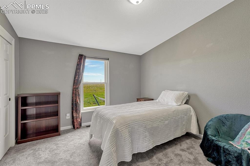 Image 31 of 50: Bedroom featuring light colored carpet l