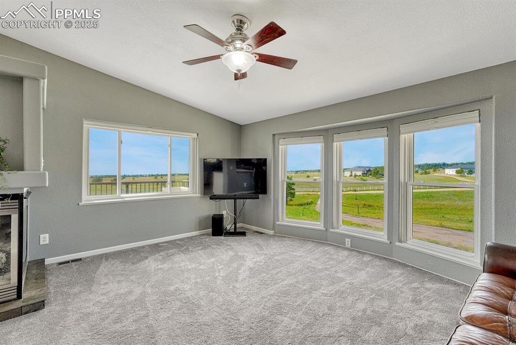 Image 33 of 50: Living room featuring vaulted ceiling, healthy amount of natural light, lig