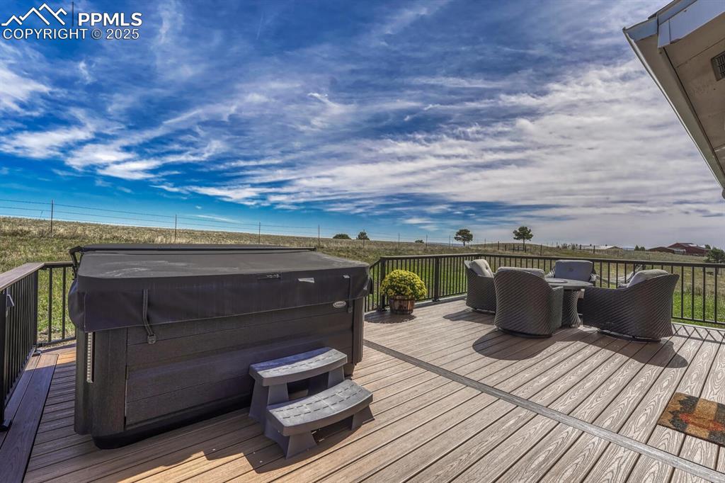 Image 4 of 50: Wooden terrace featuring a hot tub