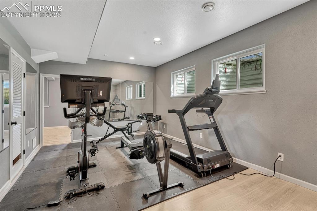 Image 44 of 50: Workout room with light wood-style flooring