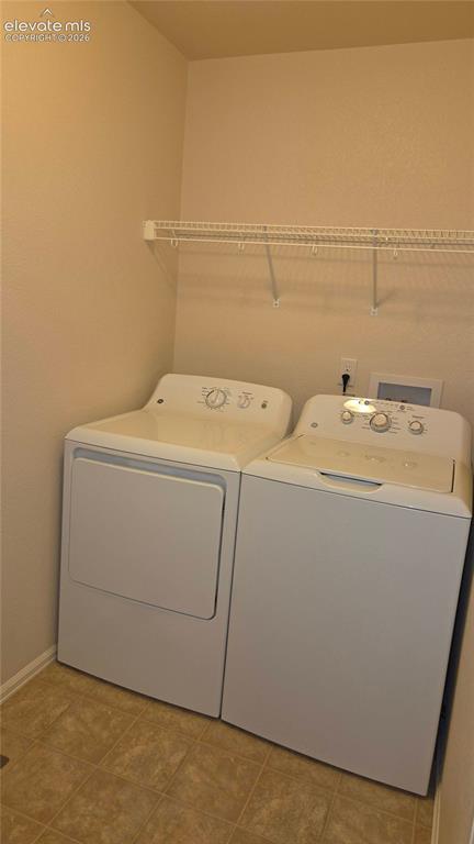 Image 10 of 23: Full laundry room w/appliances on upper level