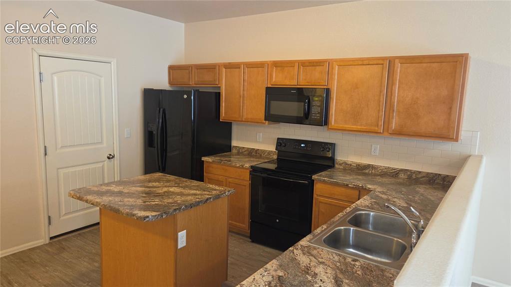 Image 17 of 23: Kitchen w/access door to garage
