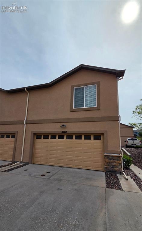 Image 19 of 23: Garage and driveway in alley